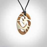 A hand carved bone contemporary, intricate pendant. The cord is a black colour and is a fixed length. A medium sized hand made contemporary necklace by New Zealand artist Kerry Thompson. Kerry has stained parts of the bone which really add to the dimension of this pendant. One off work of art to wear.